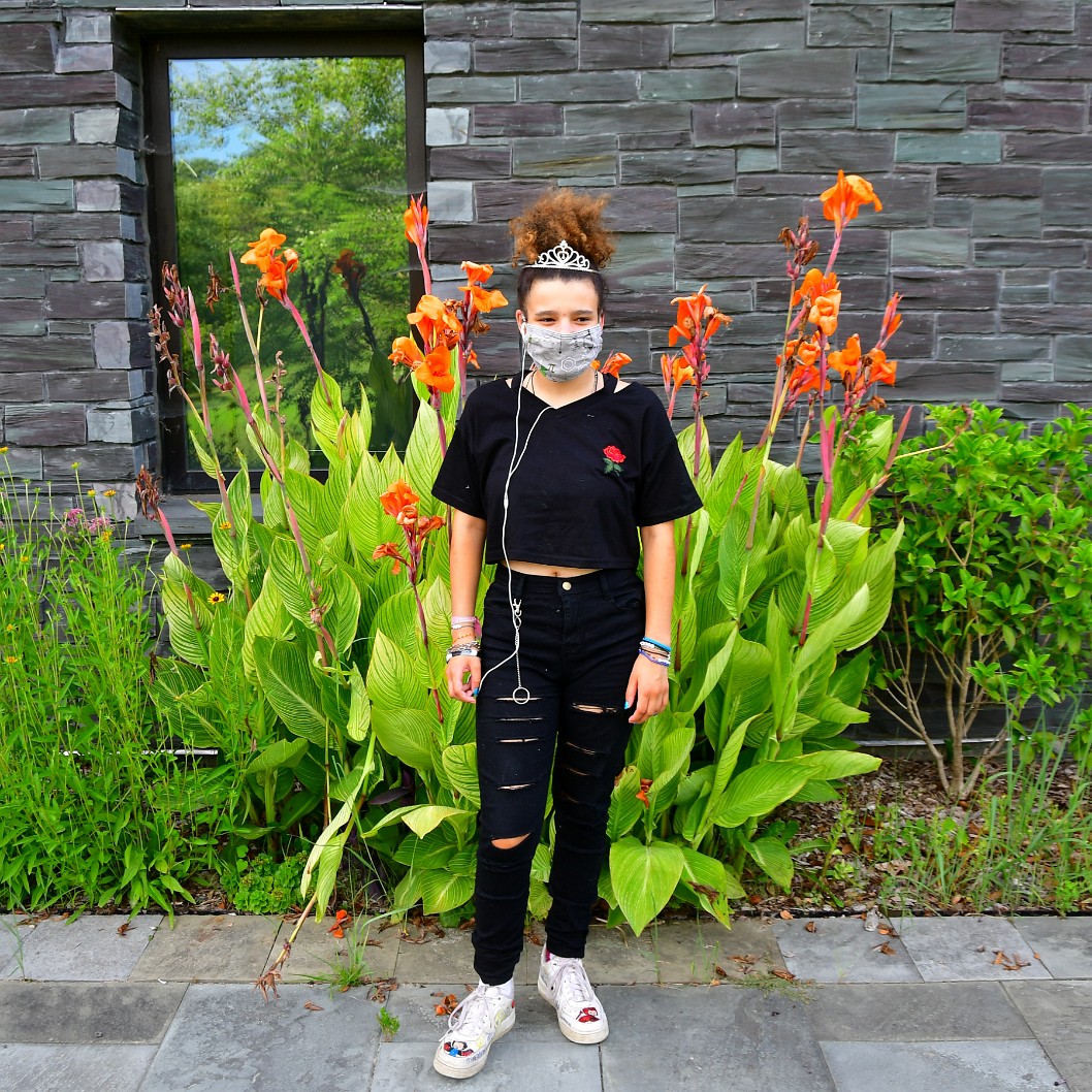 Masked Tiara Aiesha in Front of Canna Lilies
